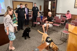 Officer Cooper and Rusty in the Select Board meeting room.