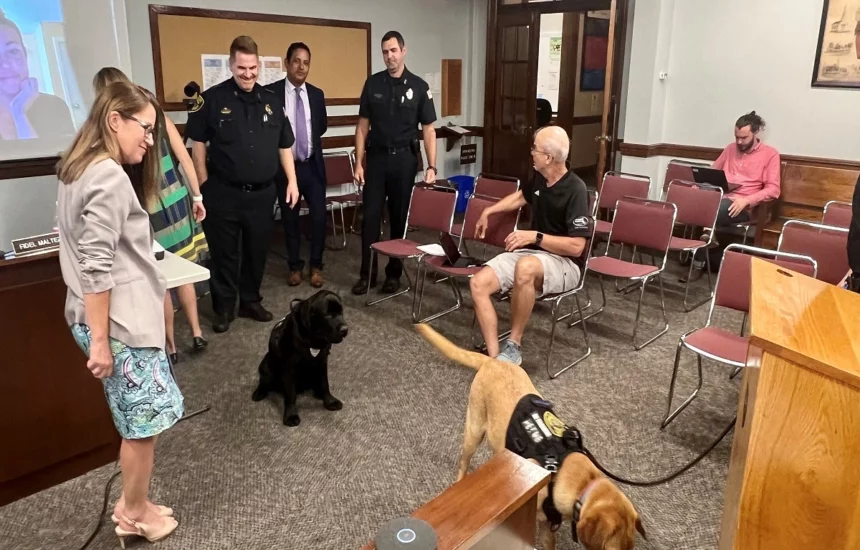 Officer Cooper and Rusty in the Select Board meeting room.