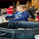 June Reese, a 4th grader at Reading’s Birch Meadow Elementary School, demonstrates the new food-waste-composting bin in the cafetorium. A pilot food-waste-composting program at the school’s Wednesday 4th–5th grade lunch period started on January 11.