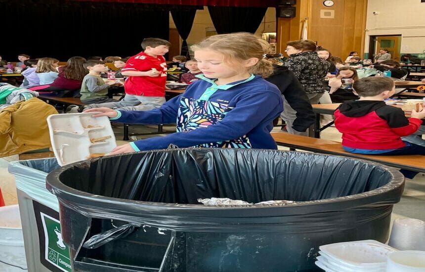 June Reese, a 4th grader at Reading’s Birch Meadow Elementary School, demonstrates the new food-waste-composting bin in the cafetorium. A pilot food-waste-composting program at the school’s Wednesday 4th–5th grade lunch period started on January 11.