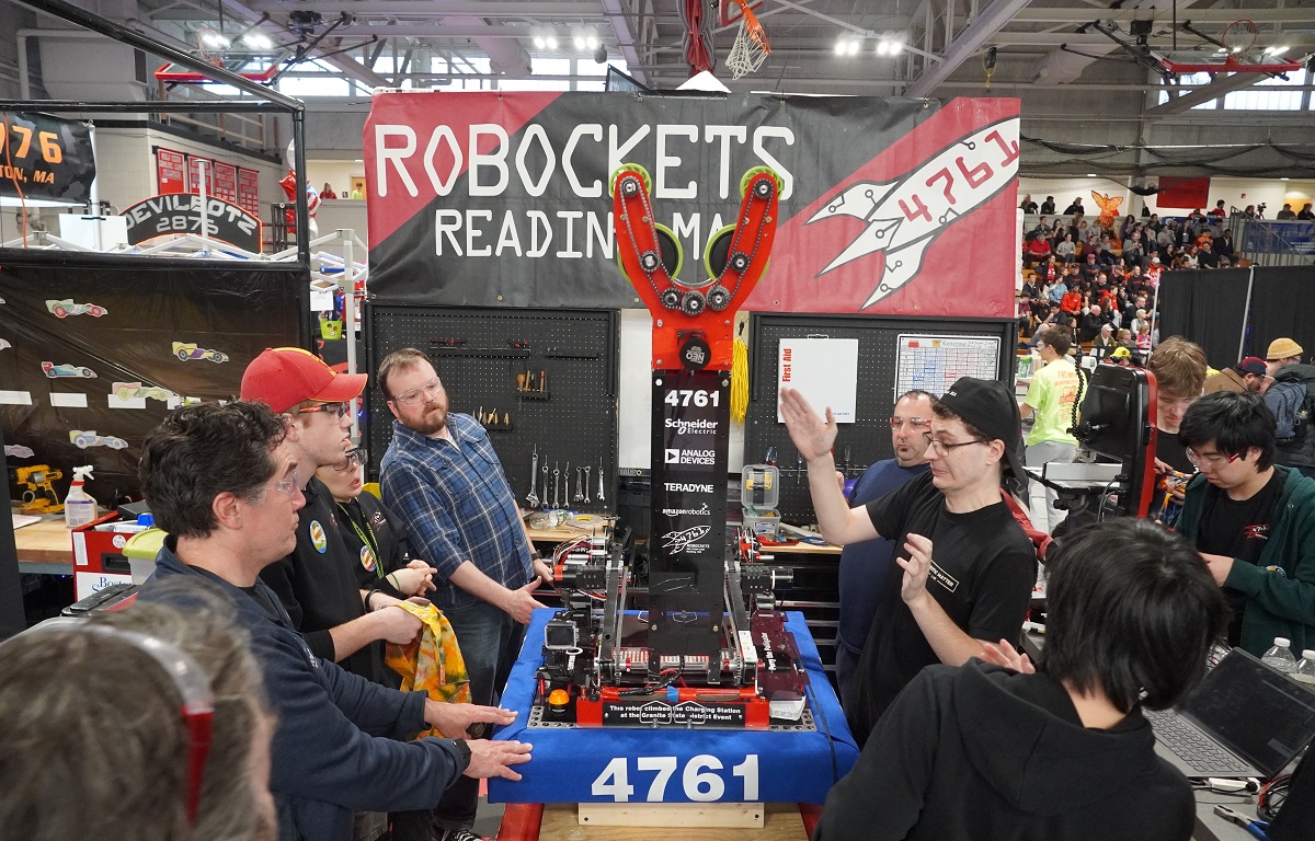 Team 4761 the Robockets robot arm swings up in the pit.