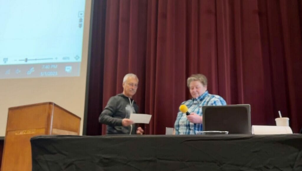 Jonathan Barnes being sworn in as temporary Town Moderator by Laura Gemme.