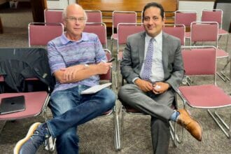 Bob Holmes of the Daily Times Chronicle (left) interviewing Fidel Maltez (right) after the meeting announcement tonight.