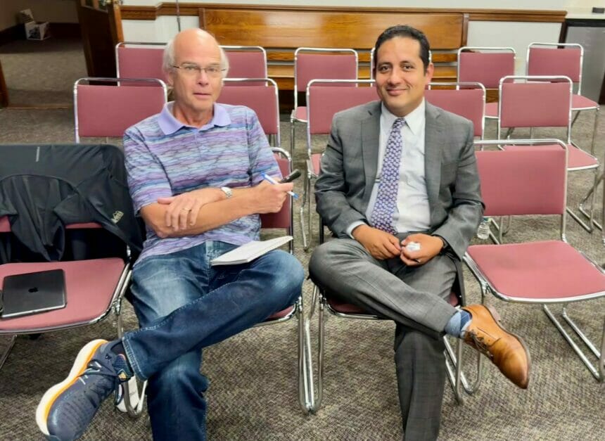 Bob Holmes of the Daily Times Chronicle (left) interviewing Fidel Maltez (right) after the meeting announcement tonight.